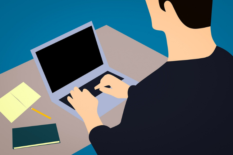 Man writing on a laptop